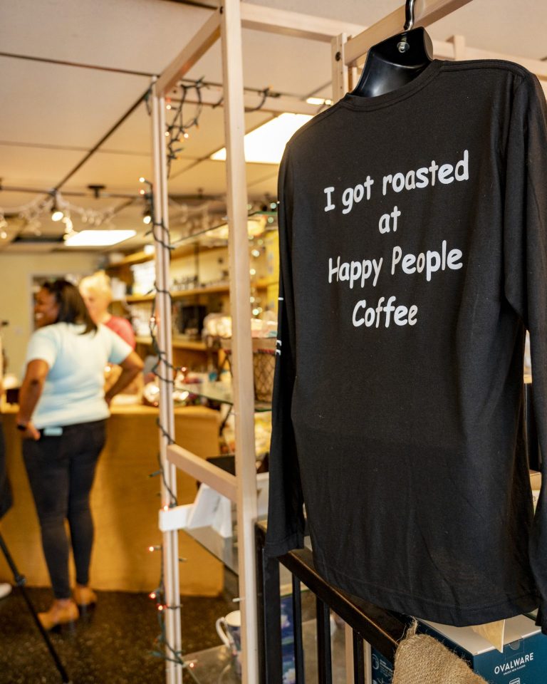t-shirt reads 'I got roasted at happy people coffee'